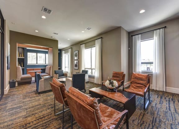 a living room with couches and chairs and a table