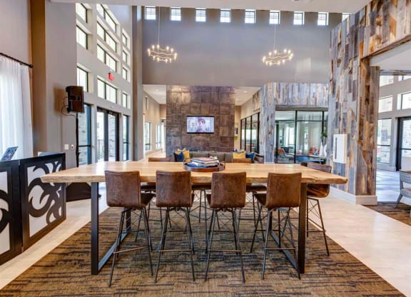 a large dining room with a wooden table and chairs