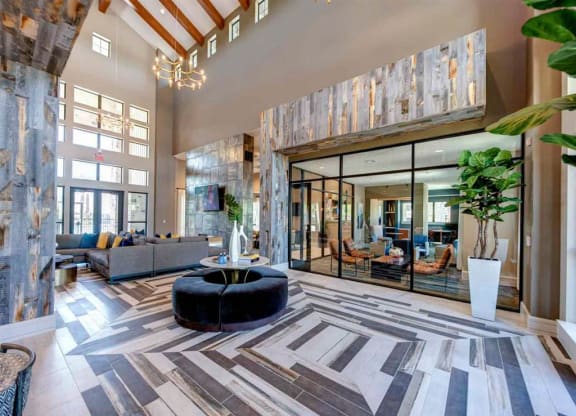 a large lobby with a large rug and a round table