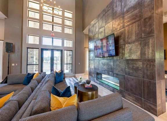 a large living room with couches and a fireplace