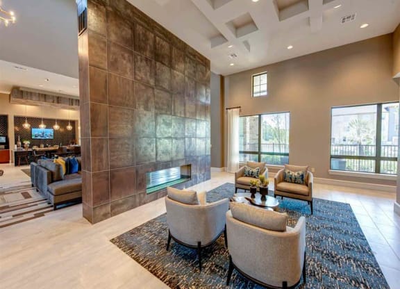 a living room with couches and chairs and a fireplace