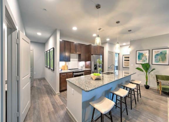 a kitchen with a long island with bar stools