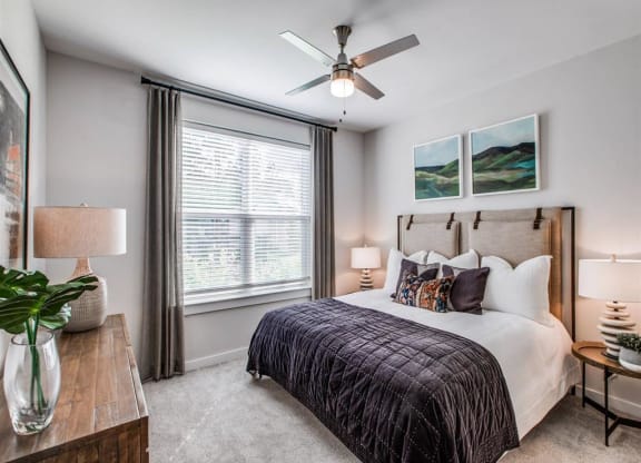a bedroom with a bed and a ceiling fan