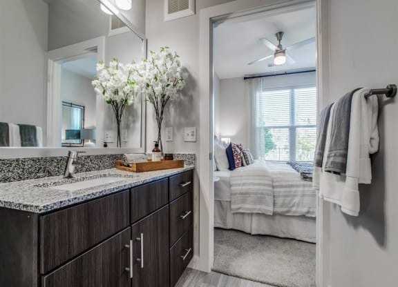 an open bathroom with a view of a bedroom