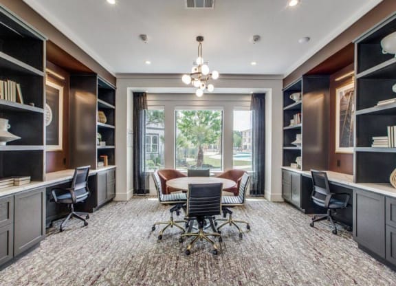a conference room with a table and chairs and a large window