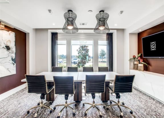 a conference room with a table and chairs and a large window