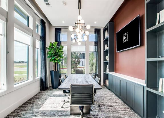 a conference room with a table and chairs and a large window