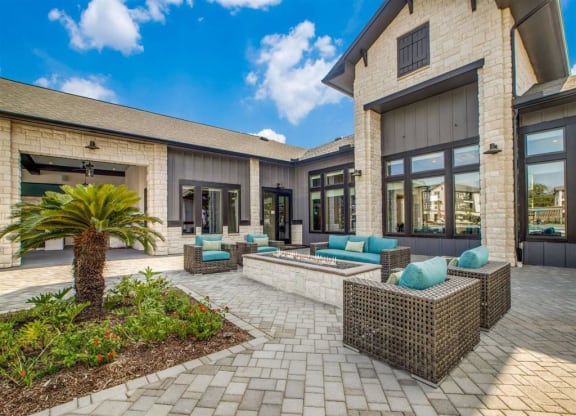 a patio with furniture in front of a house