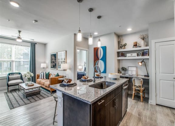 a kitchen with an island and a living room