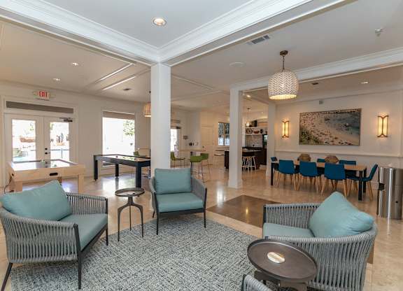 a resident clubhouse with couches tables and chairs and a pool table at Westmount at Ashwood, Atlanta, Georgia