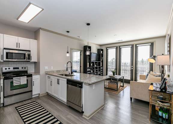 an open kitchen and living room with a view of the city at Westmount at Ashwood, Georgia, 30338