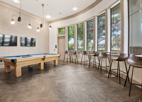 Ample seating in the lounge with a pool table at Mission Gate in Plano TX