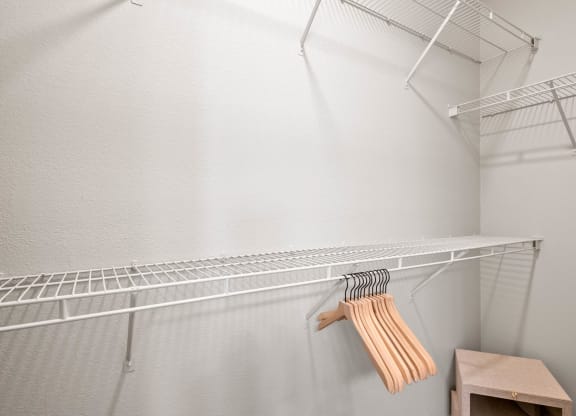 the walk in closet in the master bedroom has a wire shelf and a dresser at Mission Gate, Plano, Texas