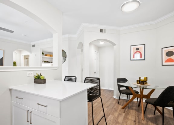 a kitchen with a white counter top and a table with chairs at Mission Gate, Texas, 75024