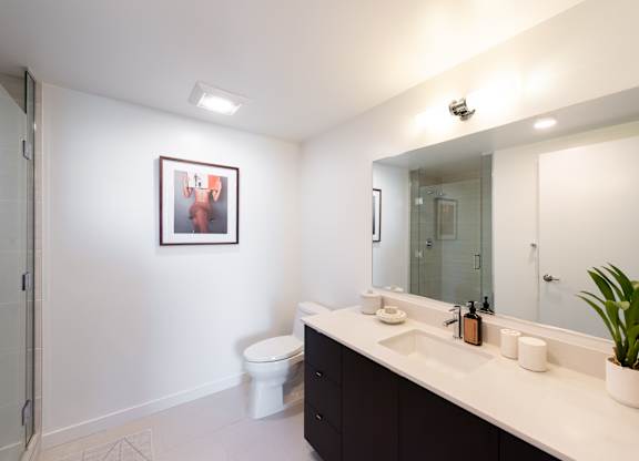 A bathroom with a white toilet and a white sink.