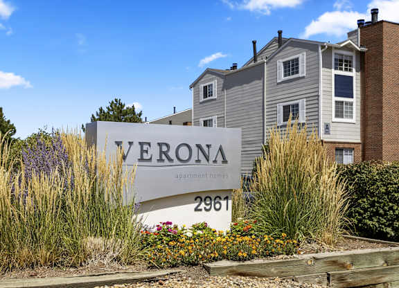 an apartment building with a sign in front of it  at Verona, Littleton, 80123