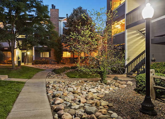 a walkway with a sidewalk and rocks in front of a house  at Verona, Littleton, CO