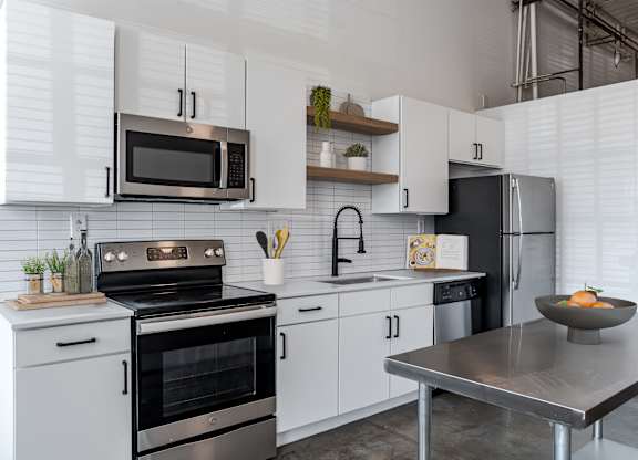 a modern kitchen with a stainless steel oven and microwave at Highland Mill Lofts in Charlotte, 28205