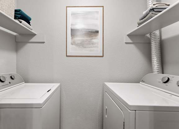 a laundry room with a washer and dryer and a painting on the wall  at Verona, Littleton, CO, 80123