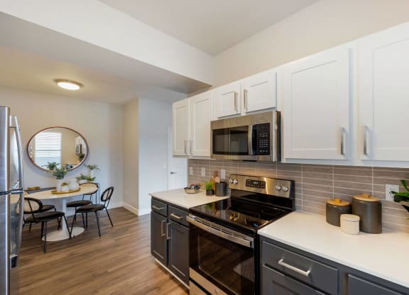 a kitchen with stainless steel appliances and white cabinets at Paisley and Pointe Apartments, Las Vegas, NV 89130