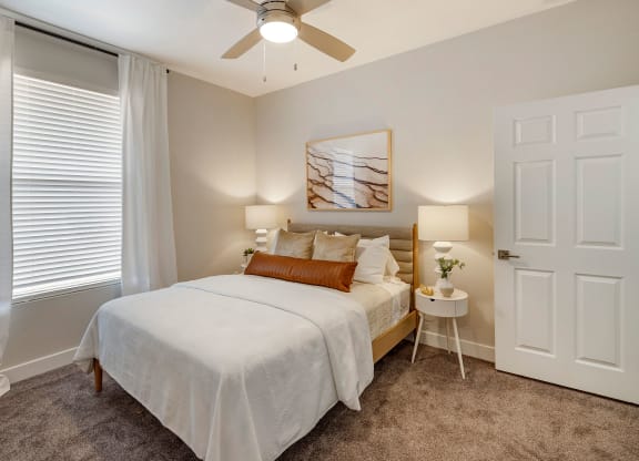 a bedroom with a bed and a ceiling fan at Paisley and Pointe Apartments, Las Vegas, NV