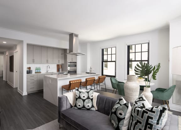 the living room and kitchen of an apartment with a couch and a table  at The Belden Stratford, Chicago, 60614