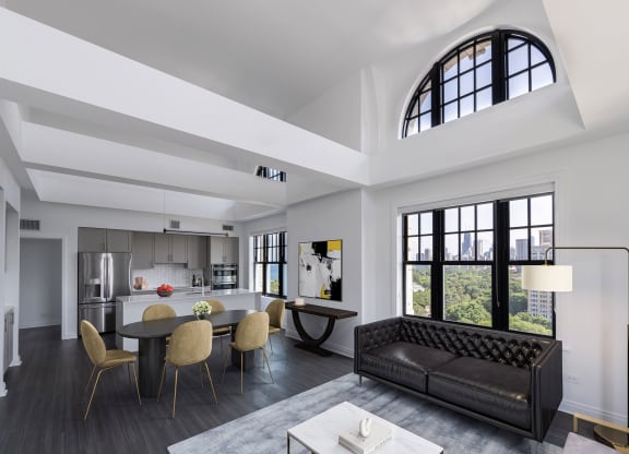 a living room with a couch and a table with chairs  at The Belden Stratford, Chicago, IL
