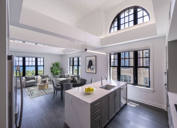 a kitchen and living room with a large arched window  at The Belden Stratford, Chicago