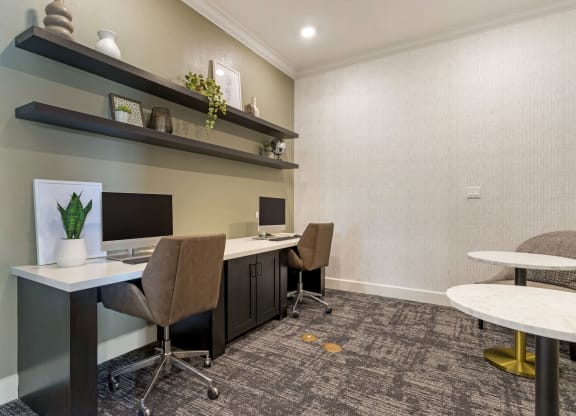 Resident Business Lounge with two desks and two computer monitors at Madison on the Meadow, Stafford, Texas