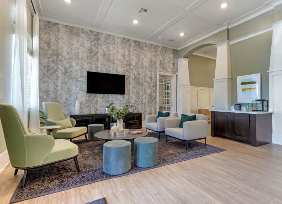a living room with couches and chairs and a fireplace at Madison on the Meadow, Stafford
