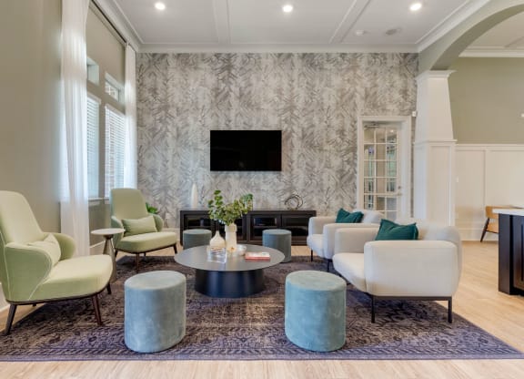 a living room with couches and chairs and a television at Madison on the Meadow, Stafford, Texas