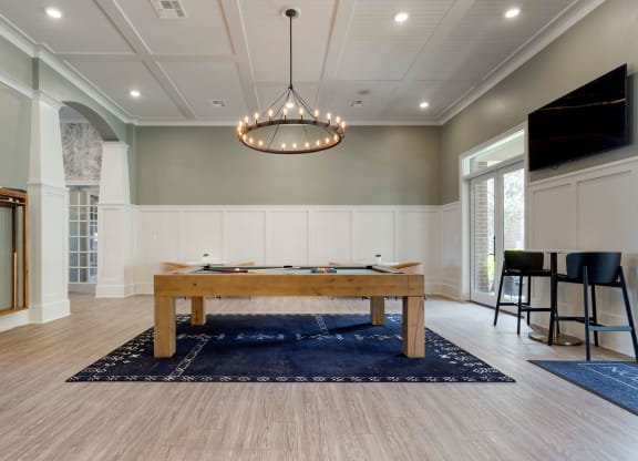 a game room with a pool table and a tv at Madison on the Meadow, Stafford, TX