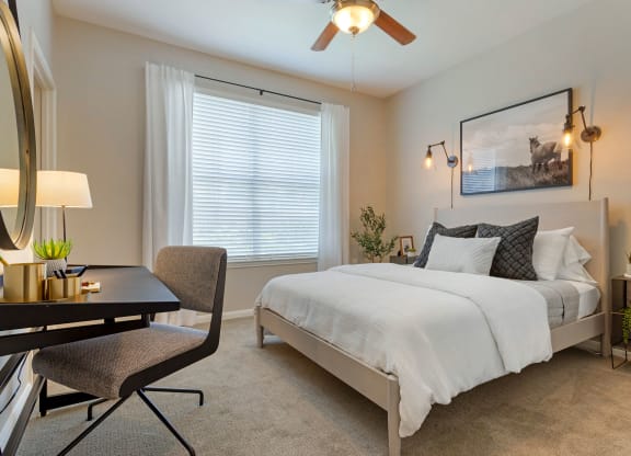 a bedroom with a bed and a desk and a window at Madison on the Meadow, Stafford, 77477