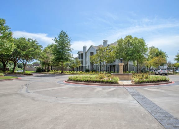 Entryway Roundabout with Apartment Building in the background at Reserve by the Lake, Houston