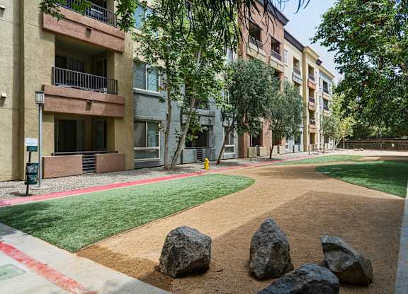 A large rock sits in the middle of a dirt path at The Kitt at Warner Center Apartments, Woodland Hills, CA