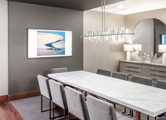 Modern dining room with a long table and grey chairs at 365 Nicollet, Minneapolis, Manchester