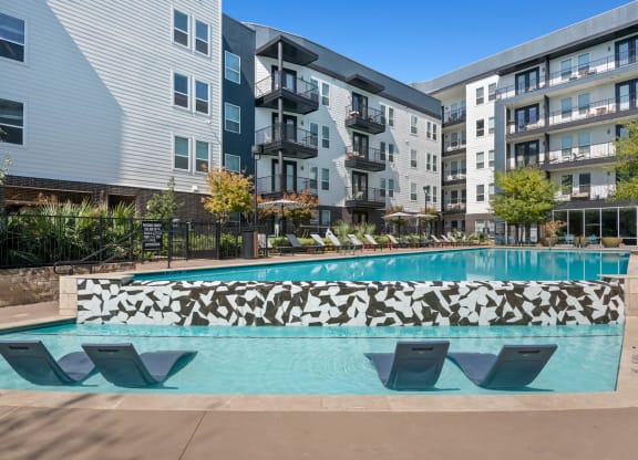 In-Water Loungers at One of Two Pools at Abstract at Design District in Dallas TX, 75207
