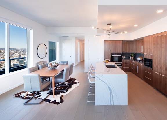 A modern kitchen with a dining table and chairs.