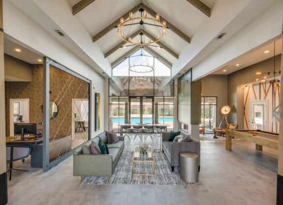 a living room with couches and a table with a pool at Carrington at Barker Cypress, Texas, 77433