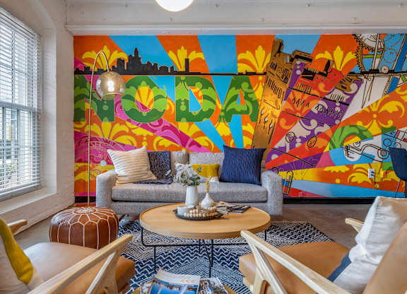 a living room with a colorful mural on the wall at Highland Mill Lofts, North Carolina, 28205