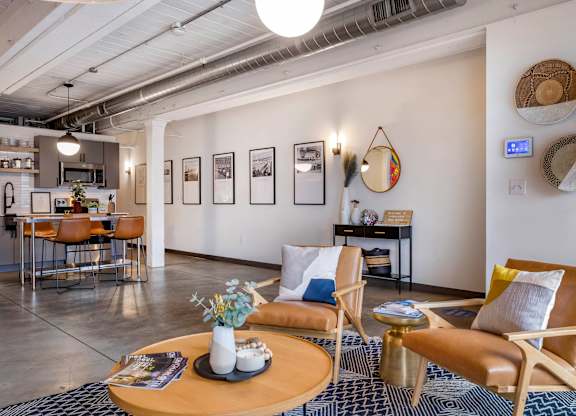 a living room with a couch and chairs and a table at Highland Mill Lofts, Charlotte, North Carolina