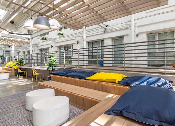 a common room with beds and a table and chairs at Highland Mill Lofts, Charlotte, 28205