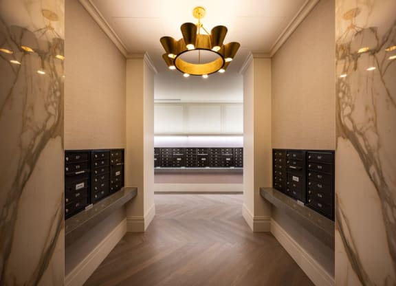 a long hallway with a chandelier and a row ofidges in a room  at The Belden Stratford, Chicago, IL
