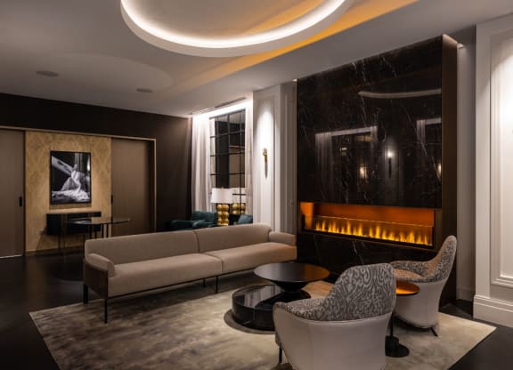 a living room with couches and chairs and a fireplace  at The Belden Stratford, Illinois