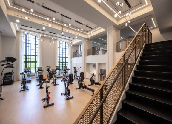 a gym with cardio machines and weights on a wooden floor  at The Belden Stratford, Chicago, Illinois
