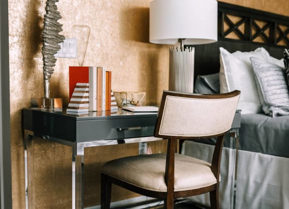a desk with a lamp and a chair in a bedroom at The Grand Central, Illinois