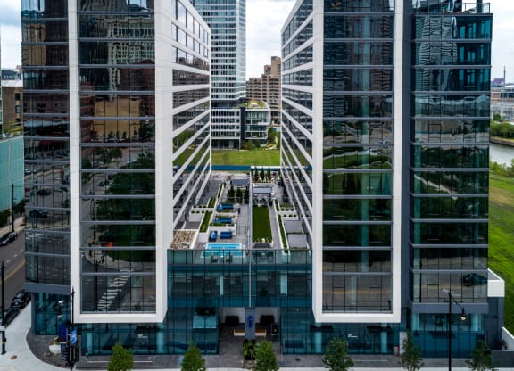 an aerial view of a city with tall buildings and a reflecting pool at The Grand Central, Chicago Illinois