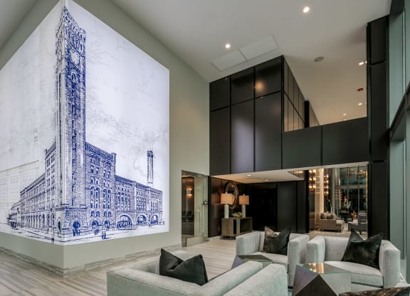 a living room with couches and a large painting on the wall at The Grand Central, Chicago