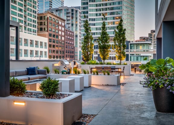 a terrace with couches and a table with plants at The Grand Central, Chicago, IL 60607