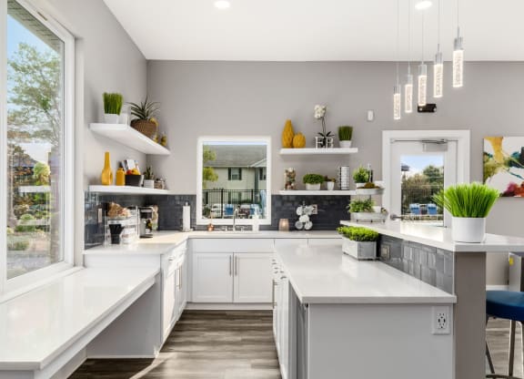 A modern kitchen with white countertops and a large island at Estates at Brentwood Lake Apartments, Ohio
